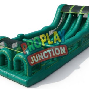 Large inflatable obstacle course with emerald green tunnels and two tall racing slides